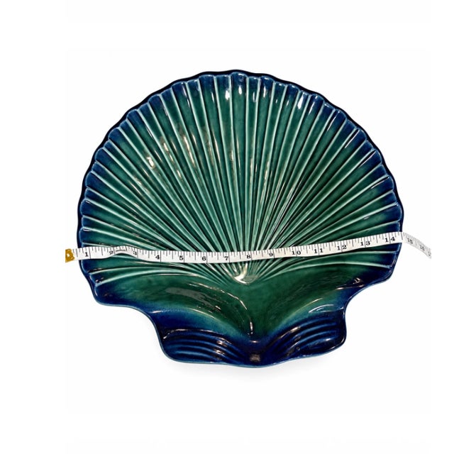 A very large shell with absolutely no intention of being subtle. This vintage Portuguese ceramic serving dish is sculpted...