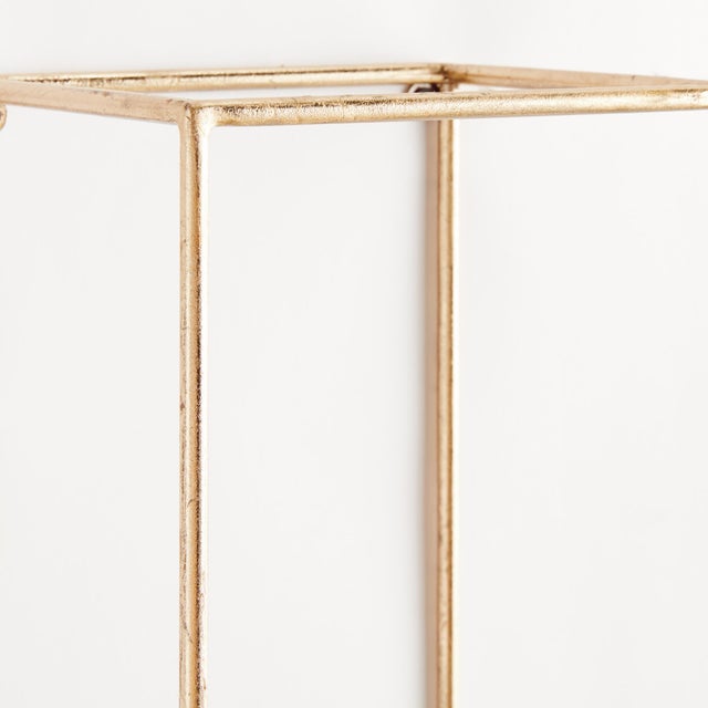 This generouslyscaled and streamlined pair of champagneGold wall shelves in various shapes are a handsome design accent....