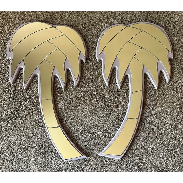 Vintage 1970’s Mid century modern pair of palm tree wall mirrors. Mirrors are mounted on 3/4” painted wood panels. They...