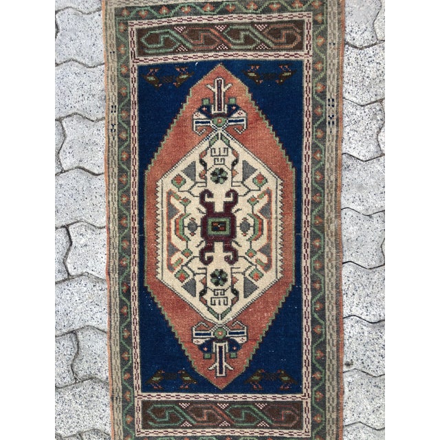 This is a vintage Turkish Oushak rug from the 1960s. The piece was hand-knotted.