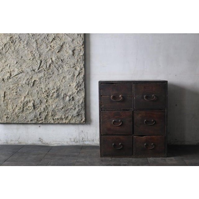 Very old Japanese small drawer storage. The furniture is from the Meiji period (1860s-1900s). It is made of cedar wood and...