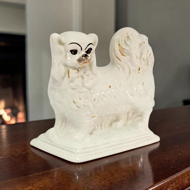 An early twentieth-century English Staffordshire-style mantel figure modelled as a King Charles spaniel, produced after...