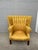 Elegant and classic grand wingback chair with a rich yellow/gold damask upholstery on a mahogany frame. Made by Ralph...