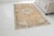 This is a vintage Turkish Oushak rug from the Mid 20th Century. The piece was hand-knotted.