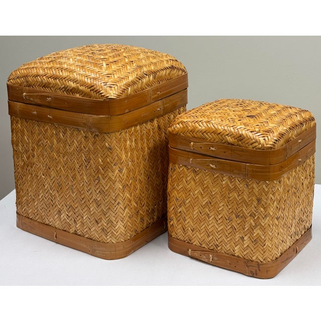 Vintage pair of rattan and woven wicker nesting baskets. Each features a sturdy frame to base and upper lip. Lovely...