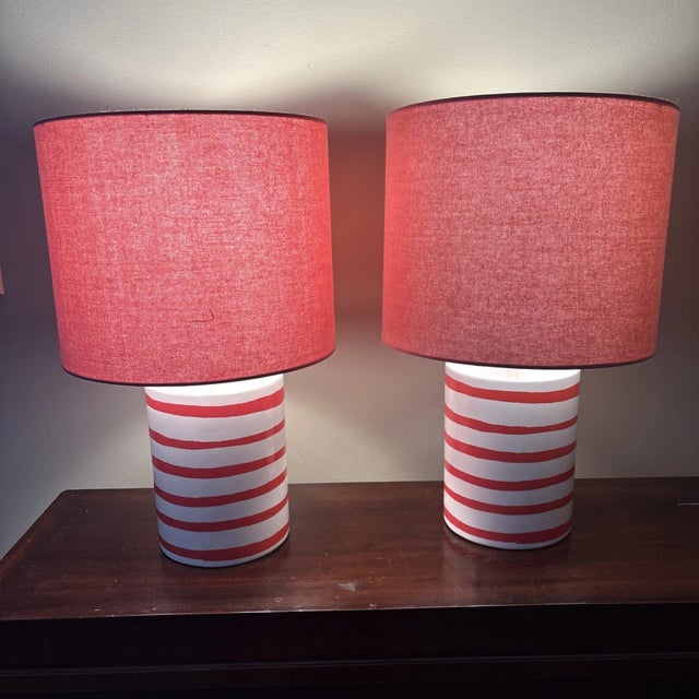 Brighten up your space with this chic set of two Kate Spade ceramic table lamps, featuring a playful pink striped design...
