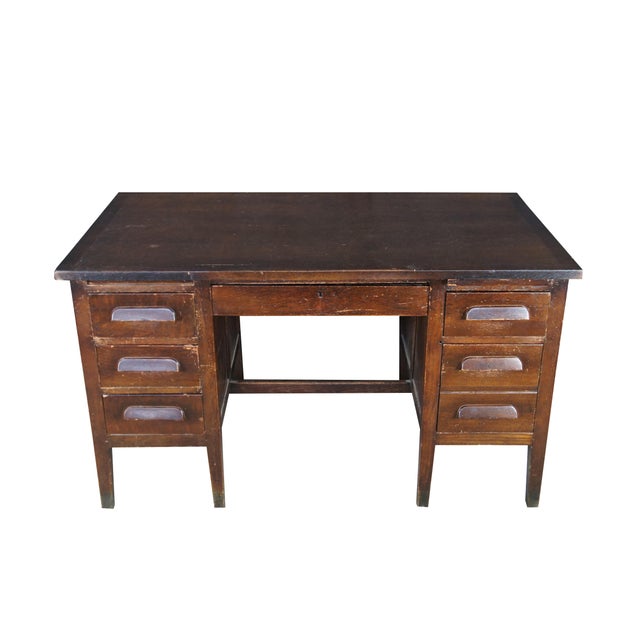 1930s vintage executive office / library / school writing desk. Made of oak featuring rectangular form with six dovetails...