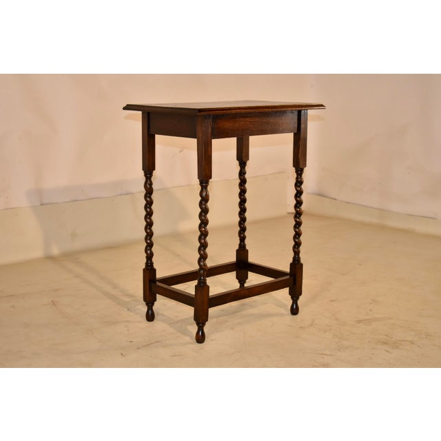 Circa 1900 Period Edwardian oak side table from England. The top is made from nicely grained oak and has beveled edges,...