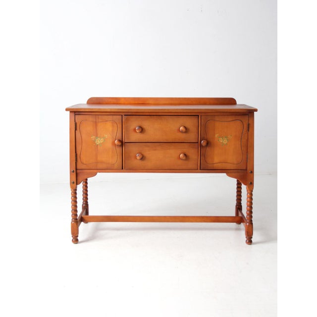 This 1930s–1940s vintage buffet by Phoenix Chair Company features a rich cherry finish and solid wood construction. Turned...
