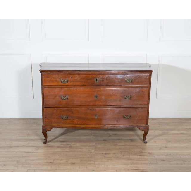 An elegant Venetian Directoire chest of drawers dating to circa 1780, crafted in solid walnut of exceptional quality. The...