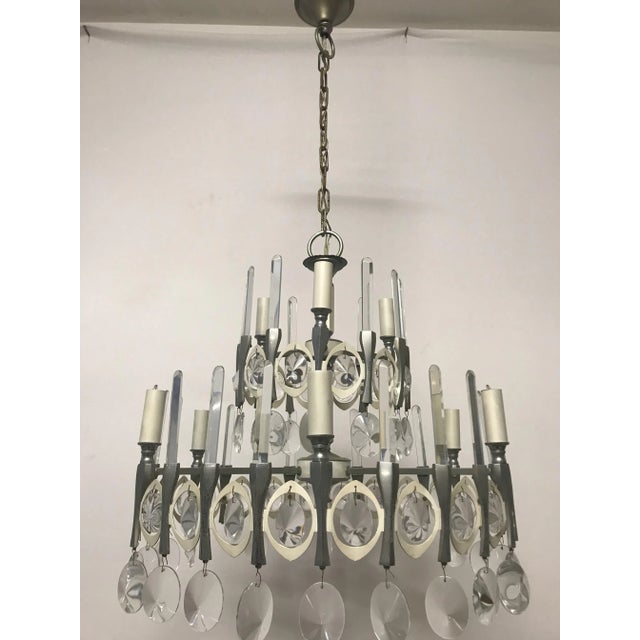 This vintage Italian chandelier, designed by Gaetano Sciolari, features nine light sockets. It measures 58 cm high with...