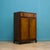 This Art Deco-style walnut compact wardrobe from Beithcraft, circa 1950s, features a pull-out rail and shelves internally....