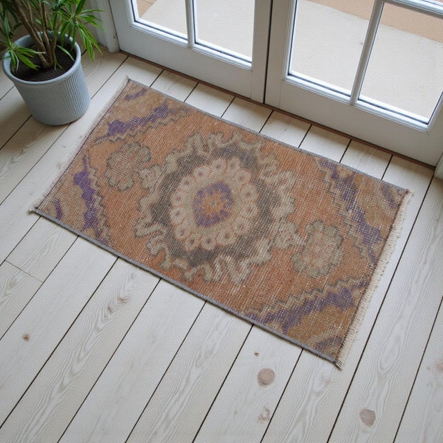 VINTAGE TURKISH NIGDE RUG 2x3 SMALL ANATOLIAN WOOL MAT MUTED ORANGE PURPLE 1970s This charming hand-knotted mat hails from...