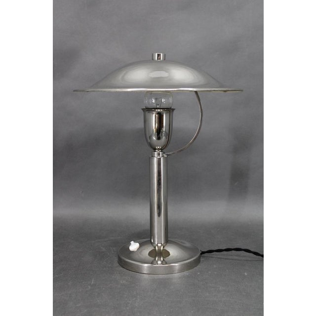 This refined art deco table lamp originates from czechoslovakia in the 1930s and exemplifies the elegance and functional...
