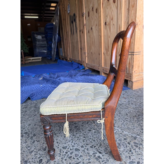 The frames feature a fluid, sweeping balloon backrest anchored by an intricately carved central horizontal stay rail...