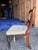 The frames feature a fluid, sweeping balloon backrest anchored by an intricately carved central horizontal stay rail...