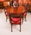 This is an elegant antique dining set comprising a regency revival flame mahogany wind-out telescoping-movement dining...