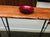 Stylish live edge console table hand crafted from red oak. Mid century style iron legs with a semi gloss finish. Lots of...