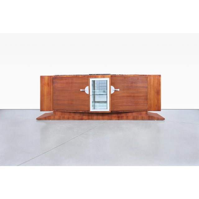 A striking example of French Art Deco design at its most refined, this monumental credenza by Maurice Rinck embodies the...