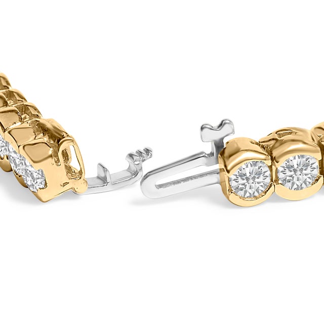 Indulge in the timeless sophistication of this tennis bracelet, crafted from lustrous 14K yellow gold. Each natural, round...