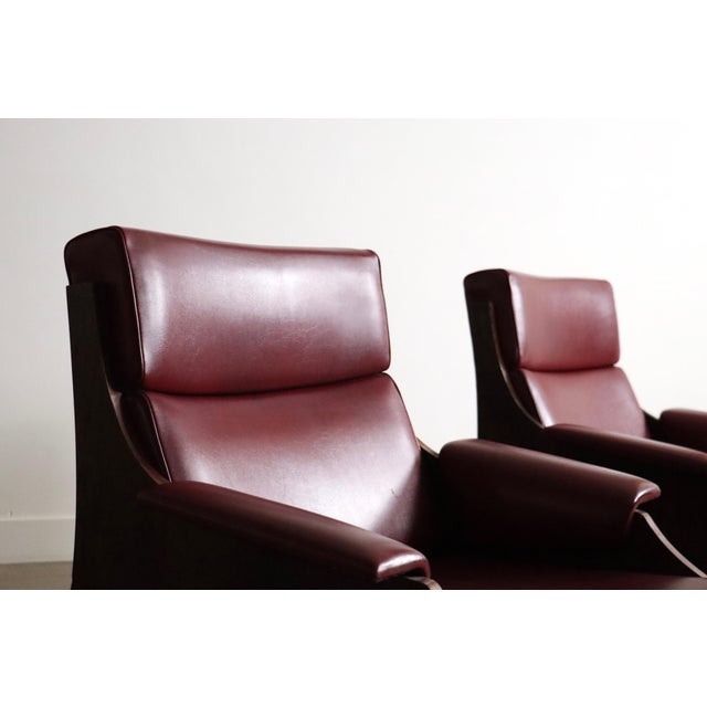 A refined pair of lounge chairs by sormani, italy, 1965. this striking design is defined by a sculptural wooden frame,...