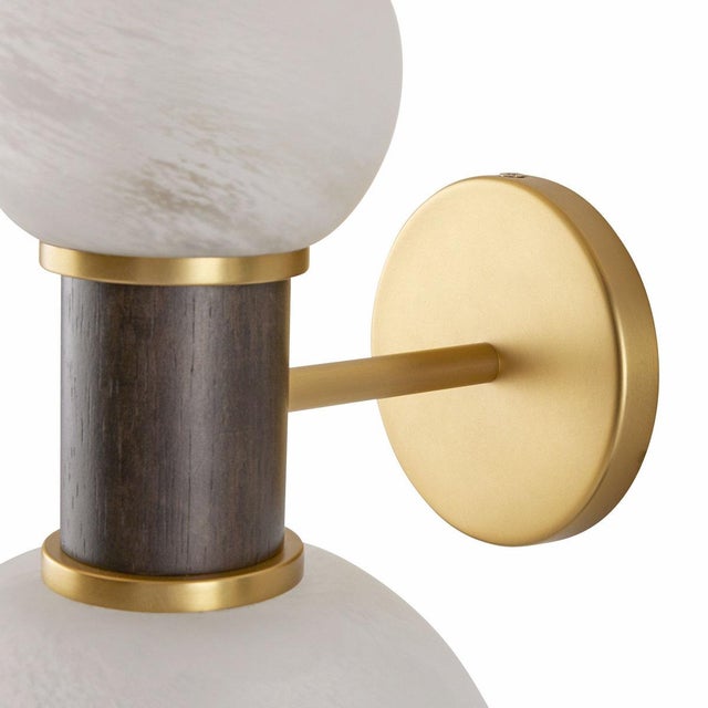 The Celestial Wall Sconce from Arteriors captivates with its unique dumbbell-style design, featuring offset globes of opal...