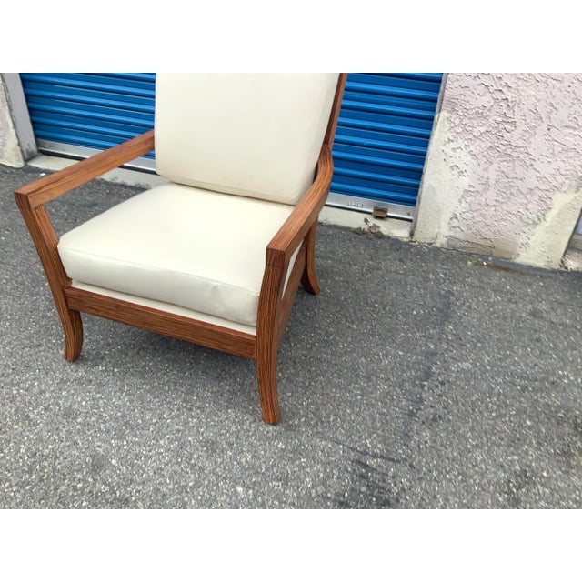 Mid century lounge chair. The chair is done in a taupe leather, cream color. The finish is a 2 tone zembrano finish. The...
