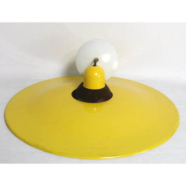 Bright yellow and black metal pendant chandelier, in the Memphis, Postmodern style ca 1980's marked Luminaire CSA. The...