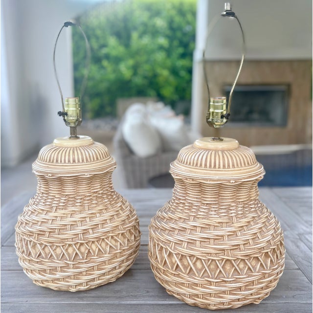 A pair of large vintage Spanish ceramic table lamps with a trompe-l'oeil wicker basketweave base in warm layered beige and...