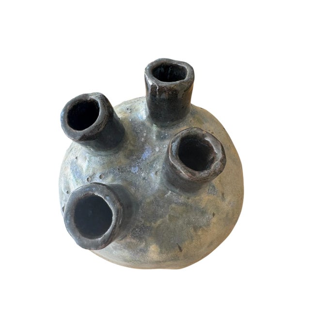 A beautiful four chambered stoneware vase glazed in deep earthtones of blues, beiges and umbers. Evocative of a heart this...