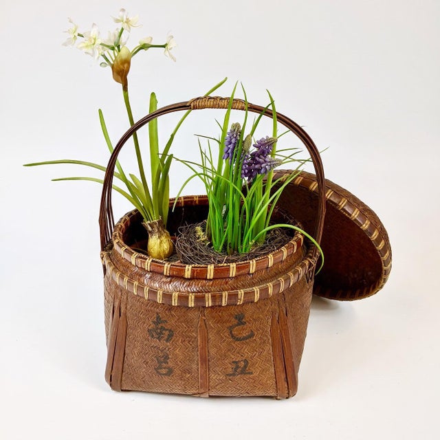 This delicate handwoven basket is from the early 20th century China. It was likely used to store food or used as a gift...