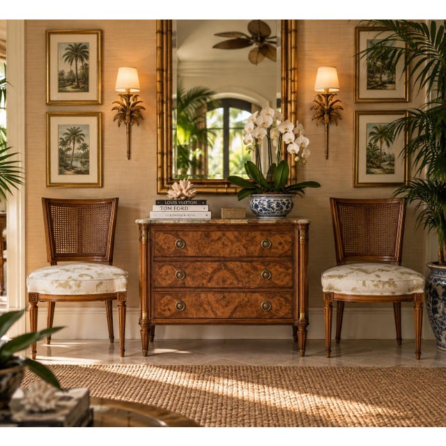 Elegant pair of Vintage French Louis XVI-style dining chairs featuring gracefully curved cane backs, carved floral...