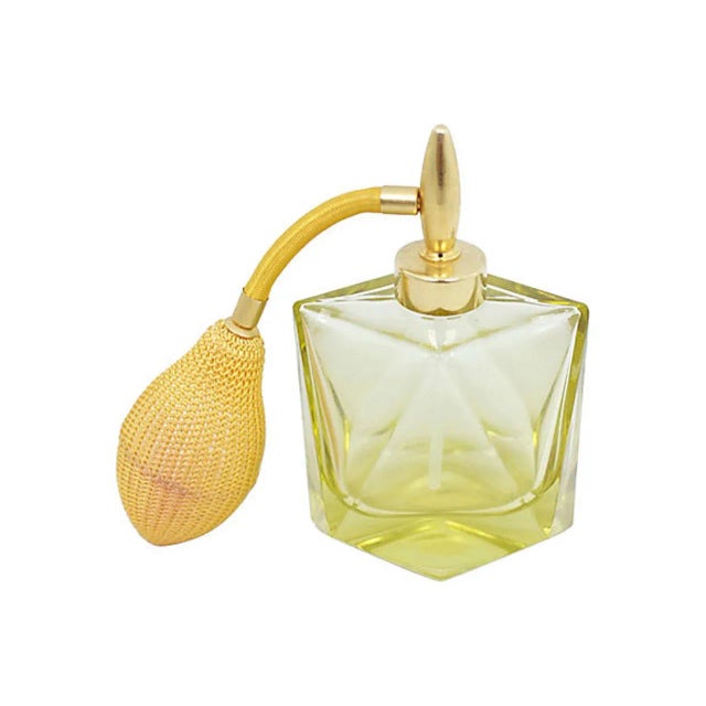 Mid-century yellow glass perfume bottle with mesh atomizer. Made in Austria. No maker's mark. Age wear to atomizer.