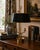 A classic bouillotte lamp rendered in warm brass, distinguished by its sculptural double dolphin motif and clean, tailored...