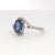 A harmonious blend of elegance and brilliance. This striking ring showcases a captivating 1.34 carat oval-cut blue...