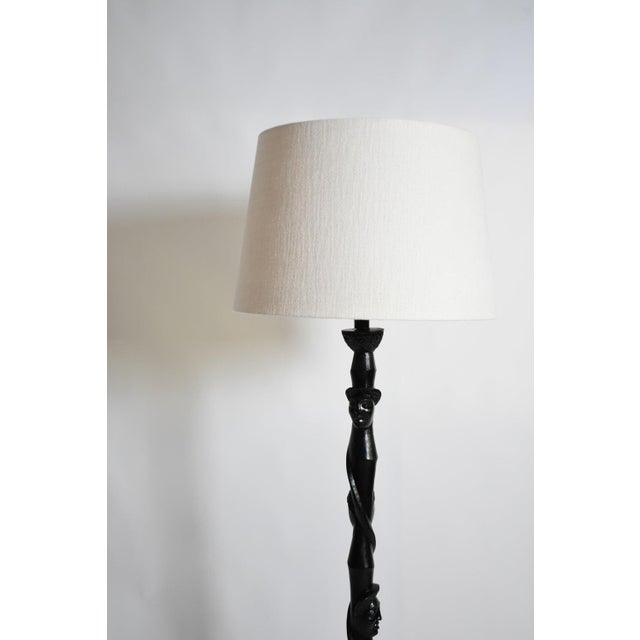 Africanist ebonised wood floor lamp, 1970s. Height: 127 cm - 50.0 in Diameter: 30 cm - 11.81 in Height with lampshade: 171...
