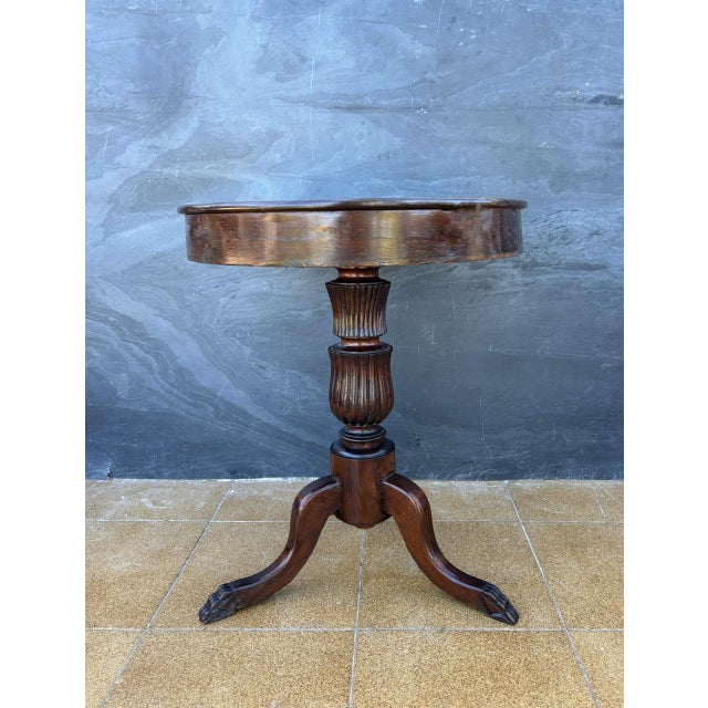 English Regency-style round side table, dating 1930s The table features a circular top supported by a turned central...