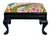 A striking ebony footstool upholstered in a zany, colorful printed linen by Clarence House. The deep ebony frame provides...