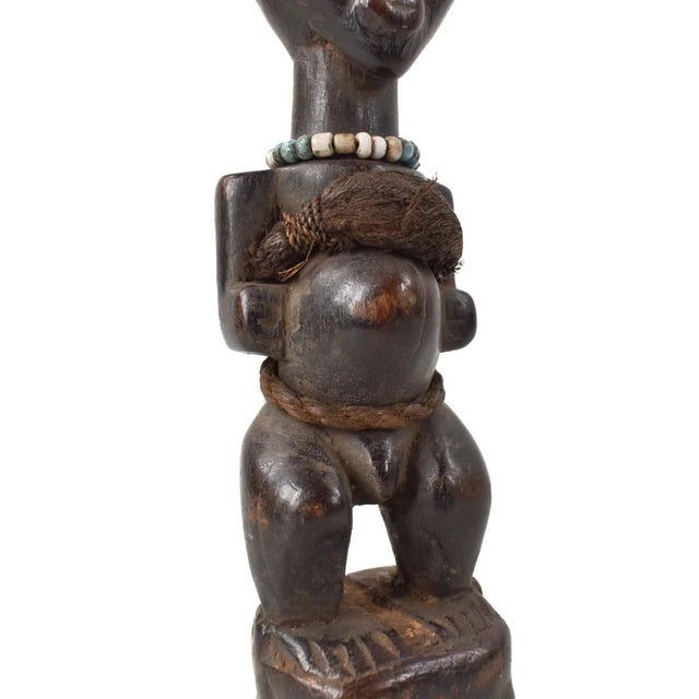 A fantastic miniature Songye Power Fetish Figure from Congo. Standing at 9 inches in height, this miniature carving holds...
