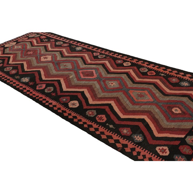 Handwoven in wool, circa 1950-1960, this 5x12 vintage Afghani tribal kilim rug, from Afghanistan, features repetitive...