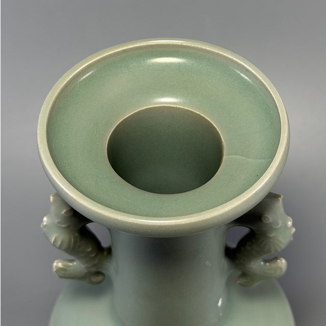 This Chinese Longquan celadon vase comes with dragon-shaped handles. The glaze has fine natural crackle. This is a...