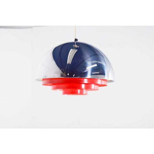 “Milieu” pendant light consists of a half globe made of chromium plated brillant with red metal louvre. with glossy outer...