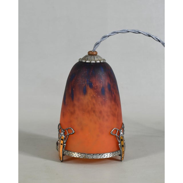 E. Val et Cie. A French 1925-1935 art deco night lamp by Eugène Val in silvered and enamelled brass. It holds a shade in...