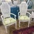 This is a pair of vintage cane back dining armchairs in a gloss white finish and freshly upholstered seats in a vibrant...