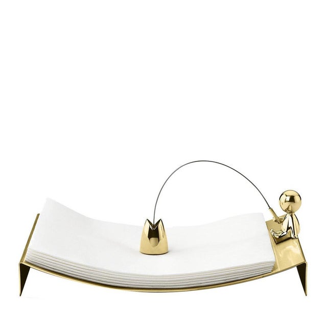 Strikingly elegant in its simplicity, this brass napkin holder boasts a concave silhouette with a shiny finish. A small...