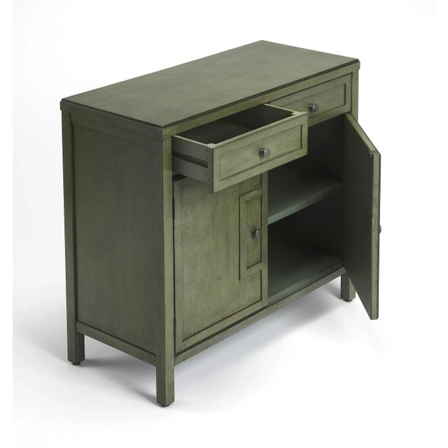 This stylish console cabinet combines Modern minimalism with Eastern design elements. Featuring clean lines and a green...