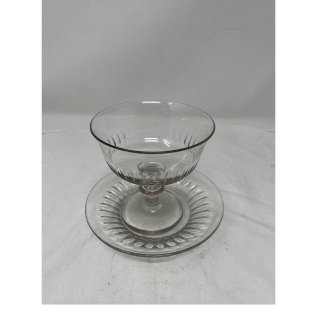 French pedestal glass candy dish with accompanying plate. This delicate piece with a striking vertical cut glass pattern...