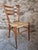 Elegant set of four Italian dining chairs dating from approximately 1950–1970, featuring slender solid wood frames, gently...