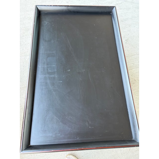 Bring timeless style and practical storage to your living space with this elegant black wood coffee table featuring a...