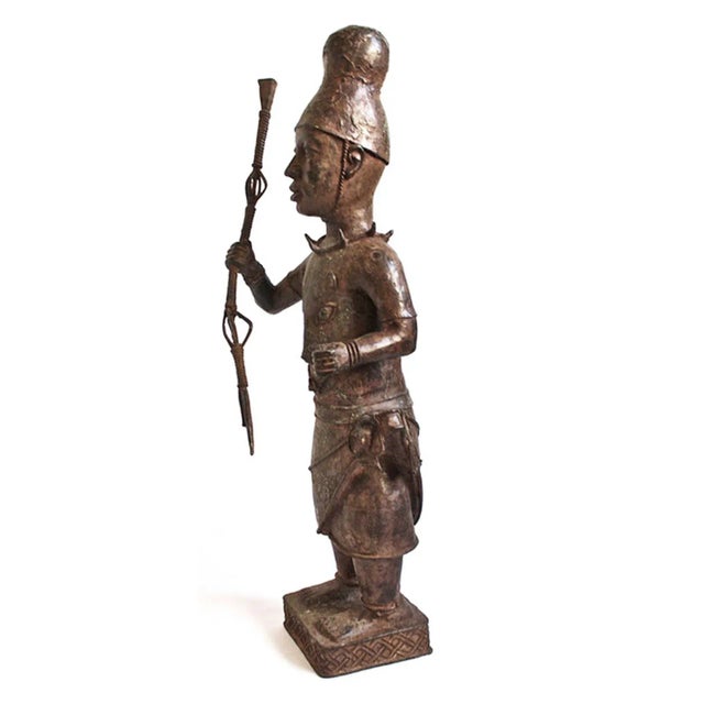 Original vintage bronze court warrior figure from the Benin Kingdom, Nigeria. This original early 1960's piece depicts the...